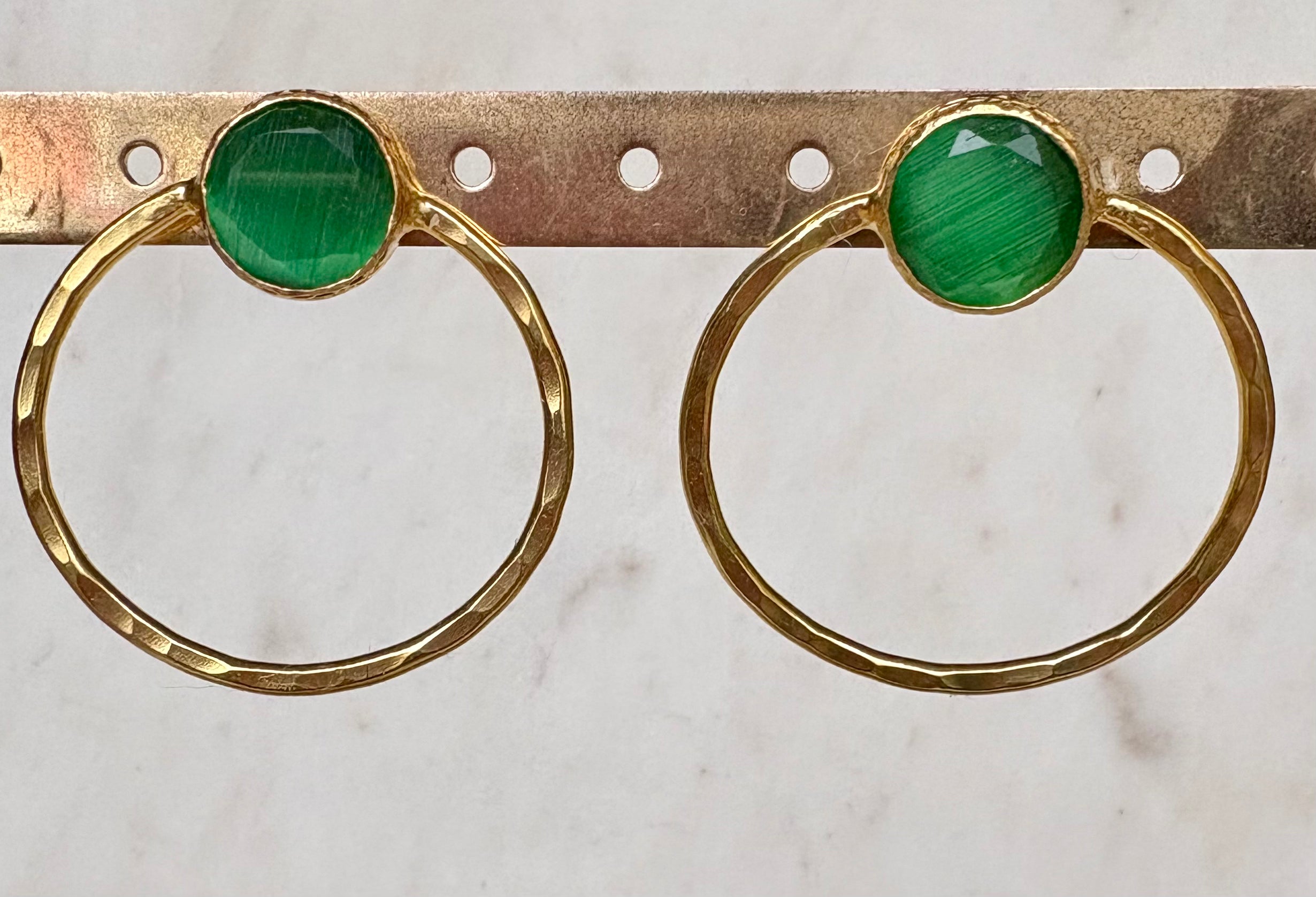 Gold hoop earrings with green gemstone