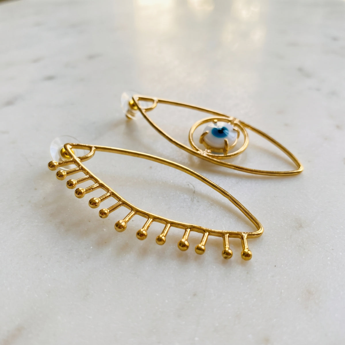 evil eye assymetrical earrings