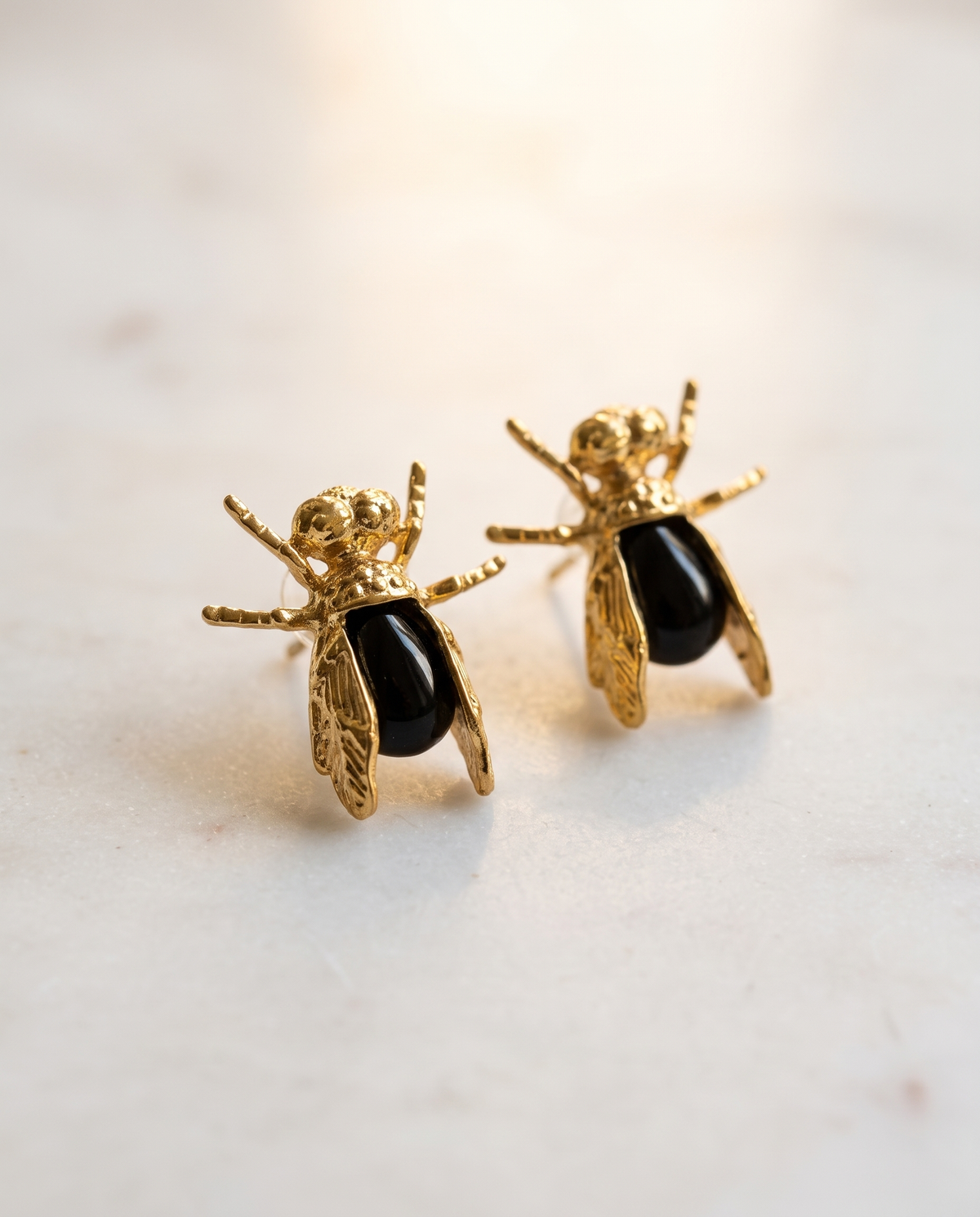 insect black gemstone earrings