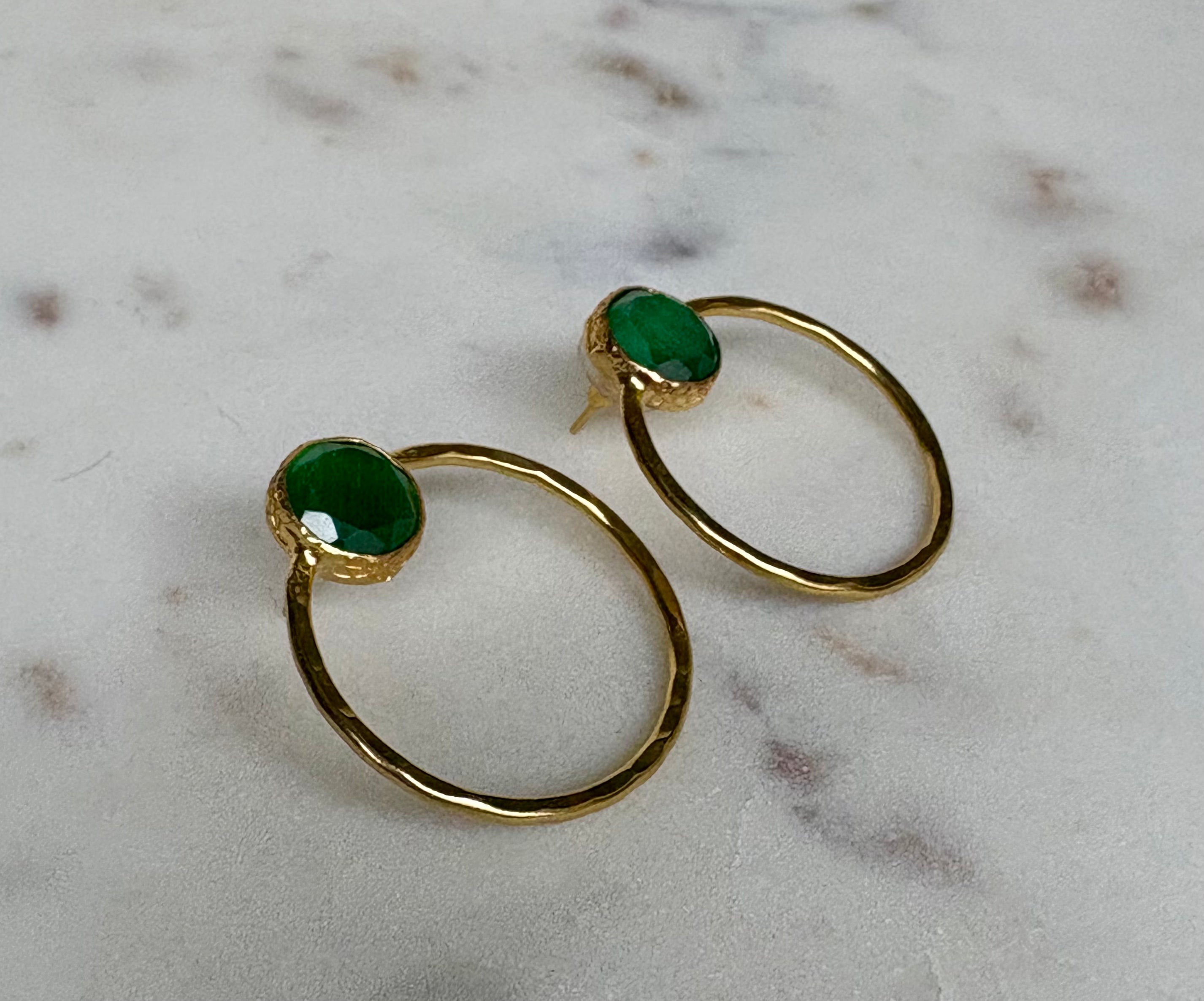 Gold hoop earrings with green gemstone