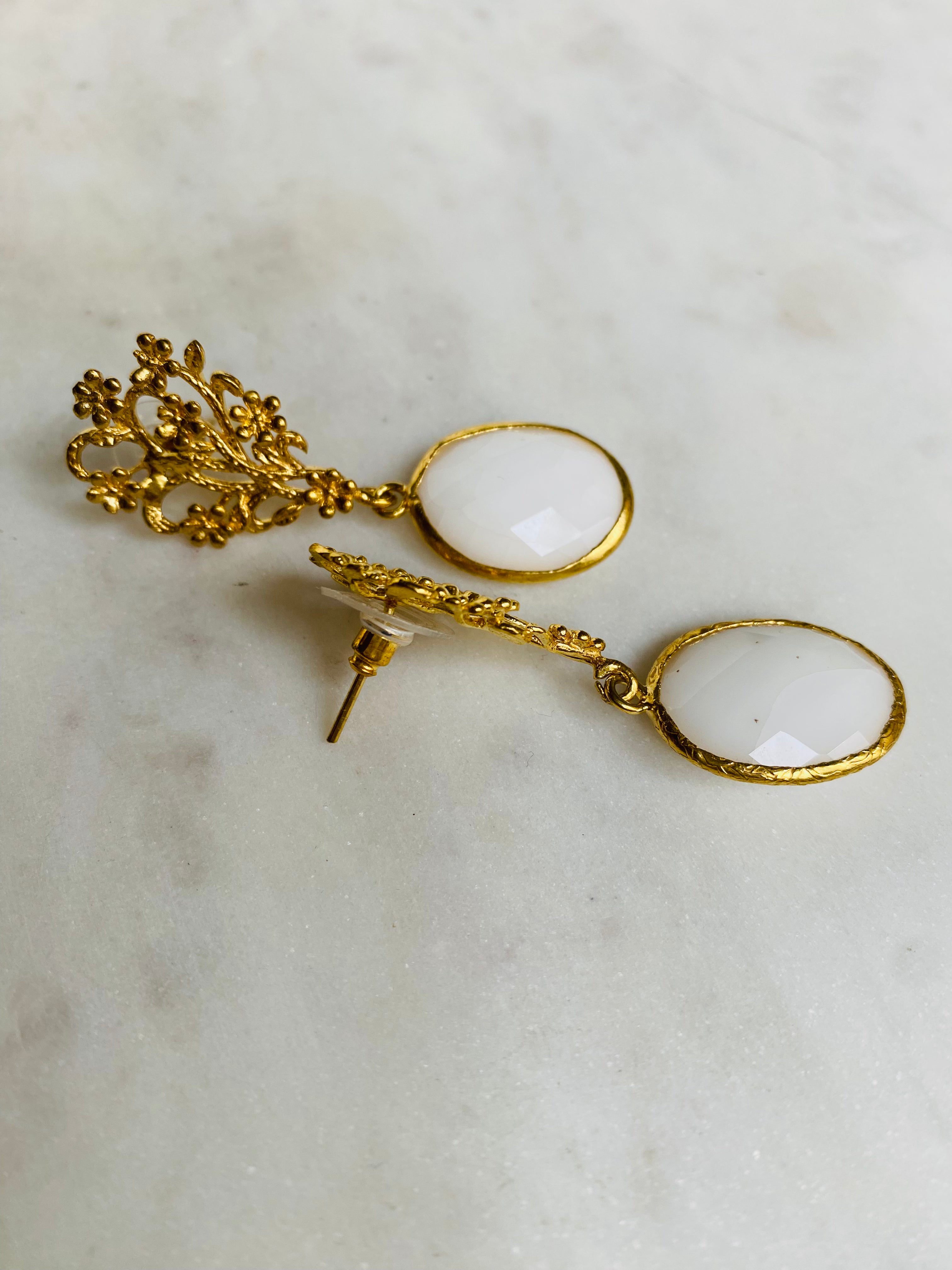 white gemstone design earrings